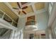 Living room featuring tall ceilings, balcony overlook, and decorative ceiling fan at 345 Phillips Dr, Fayetteville, GA 30214