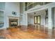 Cozy living room featuring a fireplace, built-in shelves, and a grand staircase at 345 Phillips Dr, Fayetteville, GA 30214
