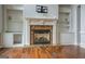Living room featuring fireplace with decorative mantel and built-in shelving at 345 Phillips Dr, Fayetteville, GA 30214