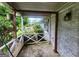 Covered porch with white railing, brick wall, and serene outdoor view at 30 Millwood Dr, Covington, GA 30016