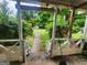Cozy porch with seating area and view of the landscaped backyard and greenery at 30 Millwood Dr, Covington, GA 30016
