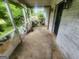 Charming side porch featuring seating and view of the well maintained yard at 30 Millwood Dr, Covington, GA 30016