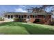 Charming red brick home with well-manicured lawn, complemented by mature shrubbery and a classic front door at 1745 Rockbridge Nw Rd, Conyers, GA 30012