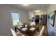 Bright eat-in kitchen with stainless steel appliances, white cabinetry and a modern dining table set at 1745 Rockbridge Nw Rd, Conyers, GA 30012