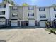 A row of two-story townhomes featuring attached garages, driveways, and neutral exteriors at 23 Corinth Rd, Cartersville, GA 30121