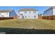 An expansive, grassy backyard featuring a privacy fence and the rear of the home at 255 Orchid Dr, Mcdonough, GA 30252