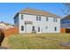 A large, grassy backyard with a privacy fence and the rear of a two-story house at 255 Orchid Dr, Mcdonough, GA 30252