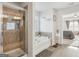 Shower and tub area in bathroom with a view into the primary bedroom at 255 Orchid Dr, Mcdonough, GA 30252