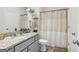 Bathroom featuring granite countertop, a shower with a striped curtain, toilet, and towel racks at 255 Orchid Dr, Mcdonough, GA 30252