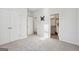 Clean bedroom features carpet flooring, white doors, and an open bathroom at 255 Orchid Dr, Mcdonough, GA 30252