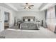 Expansive bedroom with tray ceilings, neutral carpeting, and natural light through draped windows at 255 Orchid Dr, Mcdonough, GA 30252