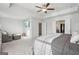 Large bedroom with ceiling fan, tv, sitting area, and neutral carpeting at 255 Orchid Dr, Mcdonough, GA 30252