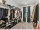 Spacious walk-in closet with ample hanging space, shelving, and a window offering natural light at 255 Orchid Dr, Mcdonough, GA 30252