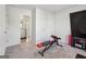 Bright exercise room featuring weight bench with doorway to bathroom with granite vanity at 255 Orchid Dr, Mcdonough, GA 30252
