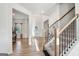 Welcoming foyer featuring hardwood floors, a staircase, and views into multiple rooms of the house at 255 Orchid Dr, Mcdonough, GA 30252