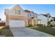 A well-maintained home with a spacious driveway, two car garage, and traditional architectural details at 255 Orchid Dr, Mcdonough, GA 30252