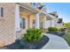 Inviting front porch enhanced by brick columns and meticulous landscaping details at 255 Orchid Dr, Mcdonough, GA 30252