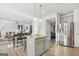 Open concept kitchen and dining room features stainless steel appliances, gray cabinets, island, and seating at 255 Orchid Dr, Mcdonough, GA 30252