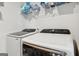 Bright laundry room featuring modern, high-efficiency Samsung washer and dryer and wire shelving at 255 Orchid Dr, Mcdonough, GA 30252