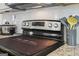 Close-up of black and stainless steel oven, tile backsplash, and granite countertop at 255 Orchid Dr, Mcdonough, GA 30252