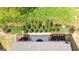 Aerial view of a backyard featuring a stone paver patio, lush landscaping, and green lawn at 5910 Stellata Cir, Cumming, GA 30028
