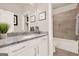 Bathroom with a white vanity, granite countertop, and a shower-tub combo at 5910 Stellata Cir, Cumming, GA 30028