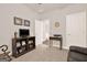 Functional bonus room with entertainment center and neutral carpet flooring at 5910 Stellata Cir, Cumming, GA 30028