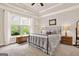 Neutral bedroom featuring large window and ceiling with decorative trim at 5910 Stellata Cir, Cumming, GA 30028
