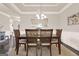 The dining room has hardwood floors, wainscoting, a light fixture, and a mirror at 5910 Stellata Cir, Cumming, GA 30028