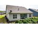 Exterior home view with a covered patio, well-maintained lawn, and lush landscaping at 5910 Stellata Cir, Cumming, GA 30028