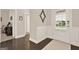 Bright entryway with hardwood floors, wainscoting, and an elegant front door at 5910 Stellata Cir, Cumming, GA 30028