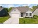 Charming single-story home featuring a two-car garage, landscaped yard, and inviting curb appeal at 5910 Stellata Cir, Cumming, GA 30028