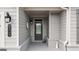Inviting covered porch, featuring a stylish front door and charming exterior decor at 5910 Stellata Cir, Cumming, GA 30028
