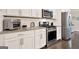 Bright kitchen featuring white cabinets, stainless steel appliances, granite countertops, and subway tile backsplash at 5910 Stellata Cir, Cumming, GA 30028