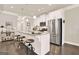 This is a well-lit kitchen with a center island, stainless steel appliances, and hardwood floors at 5910 Stellata Cir, Cumming, GA 30028