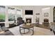 Comfortable living room featuring a fireplace, neutral tones, and a large window providing natural light at 5910 Stellata Cir, Cumming, GA 30028