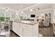 Open concept kitchen and living room featuring hardwood floors, white trim, and granite countertops at 5910 Stellata Cir, Cumming, GA 30028