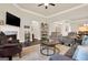 Inviting living room with a cozy fireplace, comfortable seating, hardwood floors, and an open layout at 5910 Stellata Cir, Cumming, GA 30028