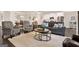 Open-concept living area featuring comfortable seating, hardwood floors, and seamless transitions to the dining and kitchen areas at 5910 Stellata Cir, Cumming, GA 30028