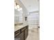 Well-lit bathroom featuring granite countertops, dark wood cabinetry, and a shower with neutral accents at 185 Discovery Lake Dr, Fayetteville, GA 30215