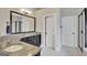 Well-lit bathroom boasts a large vanity with granite countertops, dark cabinets, and a large mirror at 185 Discovery Lake Dr, Fayetteville, GA 30215