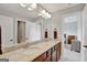 Bathroom featuring a granite countertop double vanity, large mirror, and an adjoining bedroom at 185 Discovery Lake Dr, Fayetteville, GA 30215