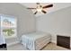 Cozy bedroom featuring a ceiling fan, neutral walls, and a window with natural light at 185 Discovery Lake Dr, Fayetteville, GA 30215