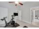 Bedroom space with neutral walls and carpet; Peloton bike is located nearby two entryways at 185 Discovery Lake Dr, Fayetteville, GA 30215