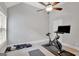 A bright room has neutral walls and carpet, perfect for a home gym with exercise bike and weights at 185 Discovery Lake Dr, Fayetteville, GA 30215