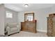 Cozy room with wooden dresser, decorative mirror, accent chair, and natural light at 185 Discovery Lake Dr, Fayetteville, GA 30215