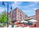 Modern building with brick facade and outdoor restaurant seating area at 185 Discovery Lake Dr, Fayetteville, GA 30215