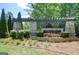 Stone sign for The Canoe Club featuring manicured landscaping and greenery around it at 185 Discovery Lake Dr, Fayetteville, GA 30215