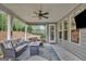 Relaxing covered patio featuring stylish seating, a fire pit table, and a serene backyard view at 185 Discovery Lake Dr, Fayetteville, GA 30215