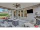 Inviting covered patio with a fire pit, comfortable seating, and a built-in grill at 185 Discovery Lake Dr, Fayetteville, GA 30215